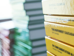 One yellow collection of books, one green collection and one red collection, all oiled up next to each other