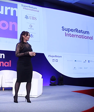 Woman speaking on the main stage at SuperReturn International